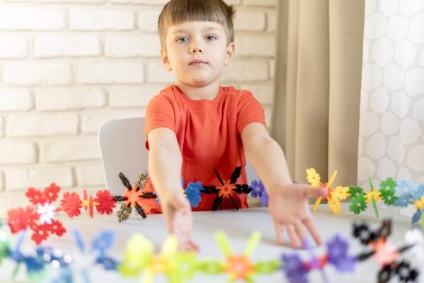 medium-shot-kid-with-floral-toy